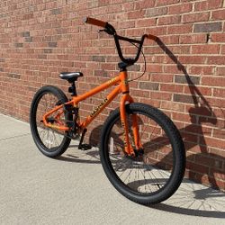 PREOWNED 2025 SE BASHER 24 OUTRAGEOUS ORANGE SINGLE SPEED FREESTYLE WHEELIE RIPPER BMX BIKE
