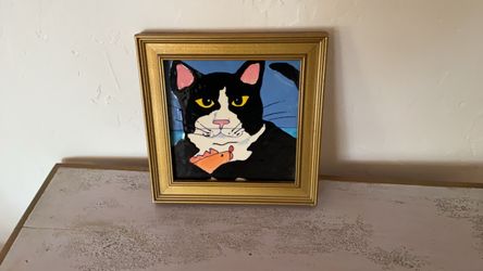 Tile in frame of Cat with his fish dinner in his paw😻