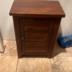 All real wood, beautiful finished beautiful grain beautiful metal handle brass could use it for a hidden table. I had it in my bathroom.