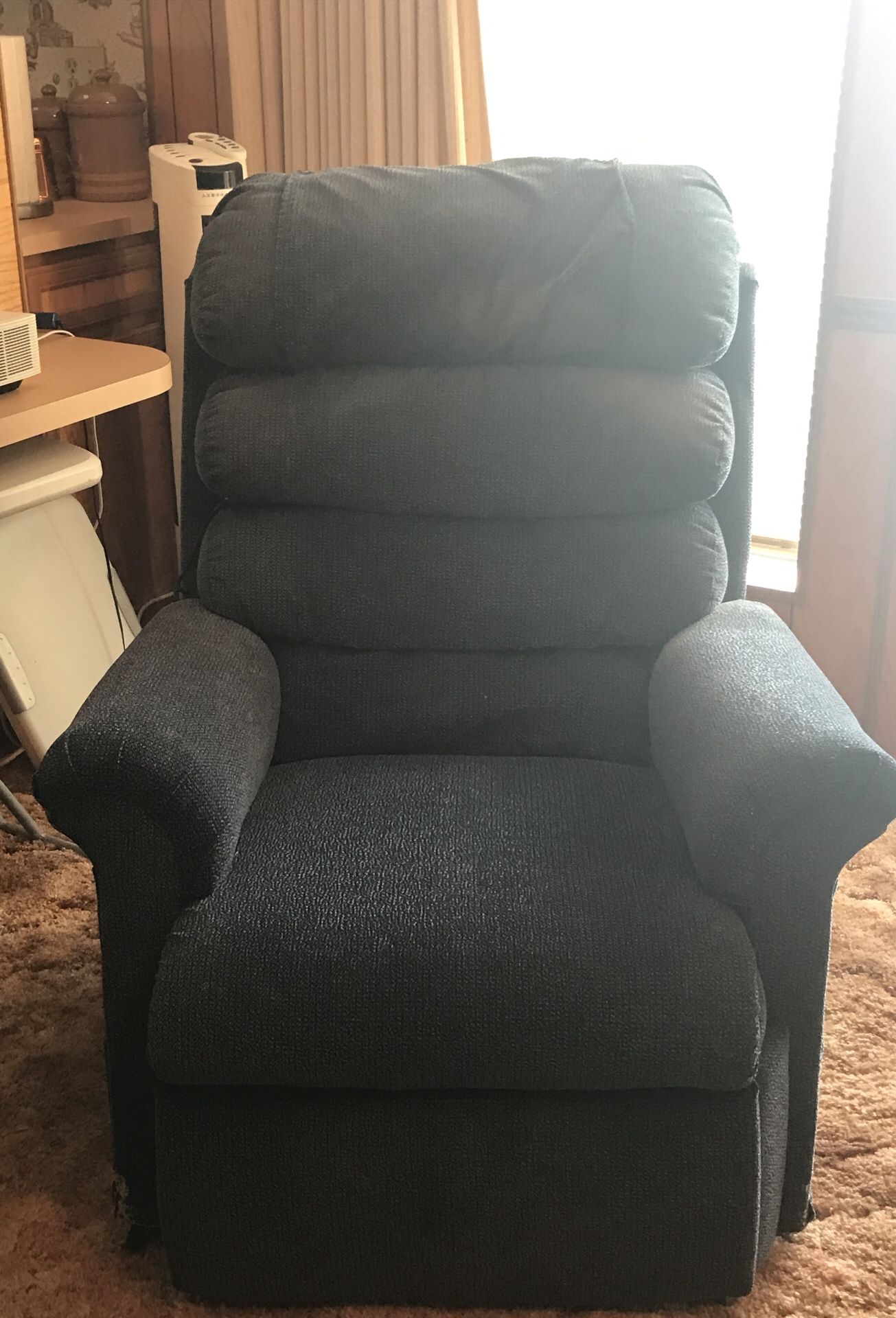 Pride blue stand up recliner.