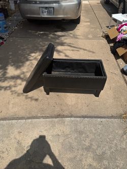 black faux-leather storage ottoman/bench.