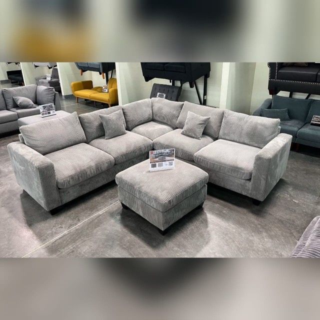 Gray corduroy sectional sofa with ottoman