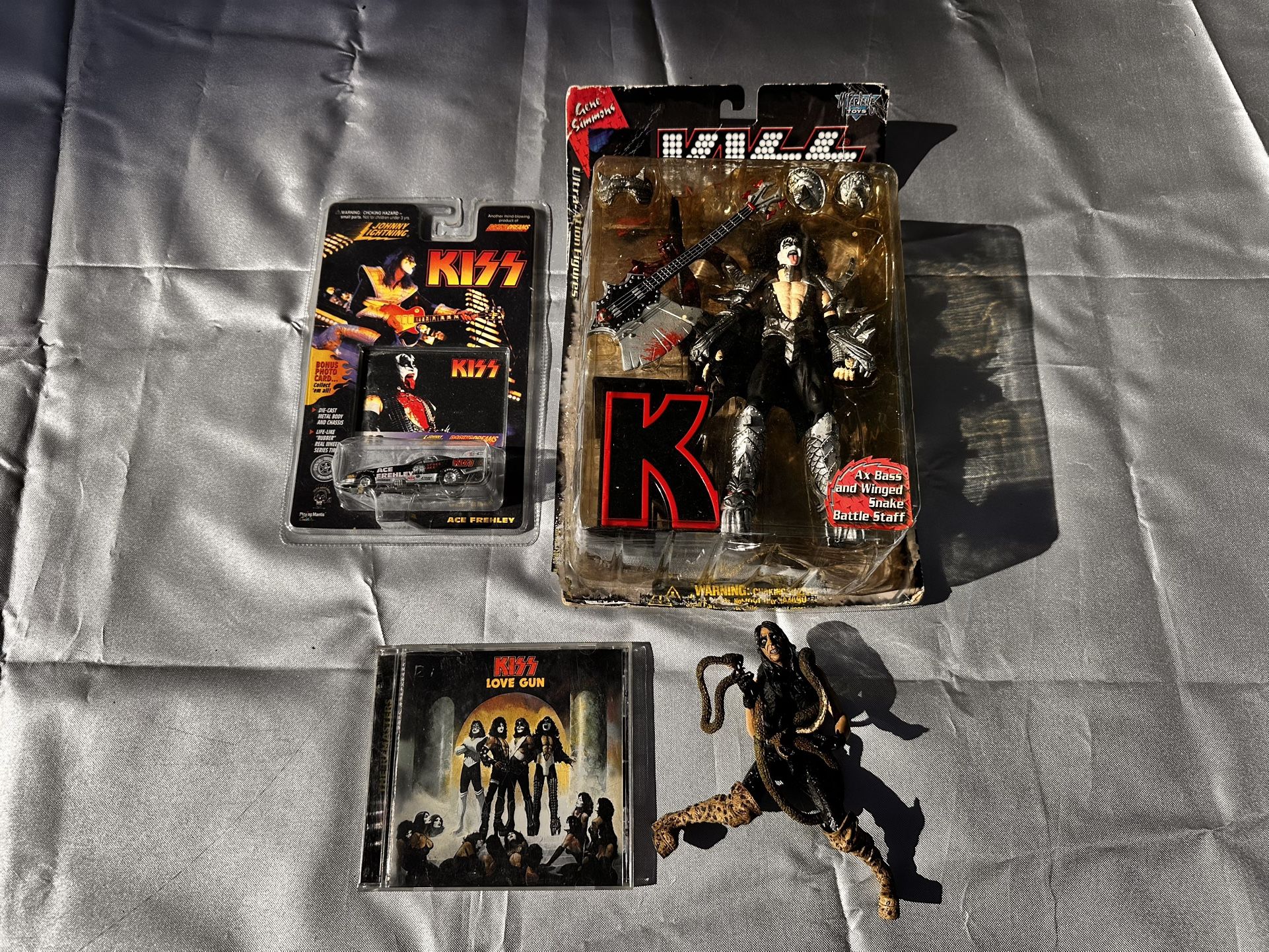 KISS Collectibles Lot – Gene Simmons Figures, Ace Frehley Car, Love Gun CD – $50 OBO