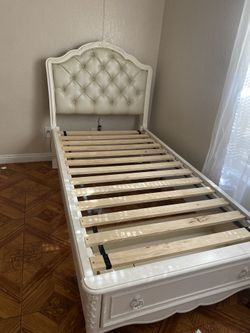 White twin bed with storage drawer