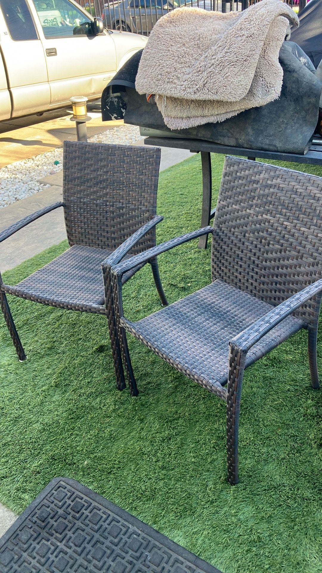 Two chairs rattan outside orchard