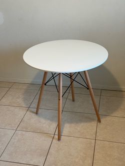 Modern white round table with wood legs