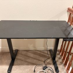 Electric desk raises up and down to adjust if you want to sit or stand. Wide enough for two monitors and keyboard and mousepad .