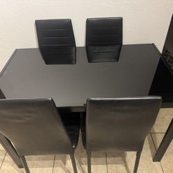 Glass table with 4 chairs in good condition, $80