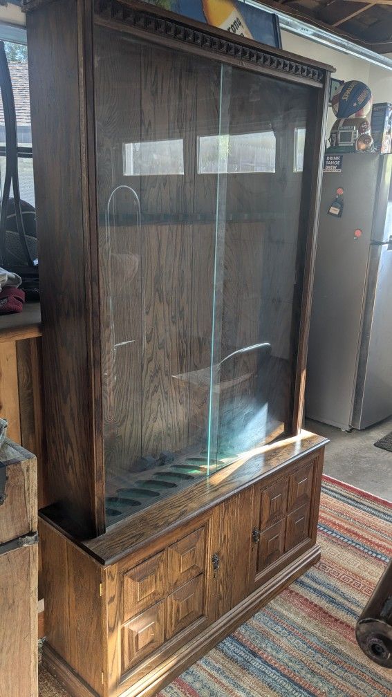 Nice solid oak rifle and fishing pole Glass cabinet
