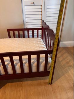 Wooden toddler bed with mattress