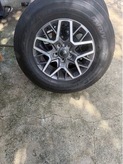 Bridgestone Set of five wheels and tires for a 2024 Jeep Wrangler Sahara.” Rim 17