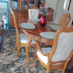 Formal Dining Table With 6 Fabric Cloth Seats Ready For Your Next Sit Down Dinner.
