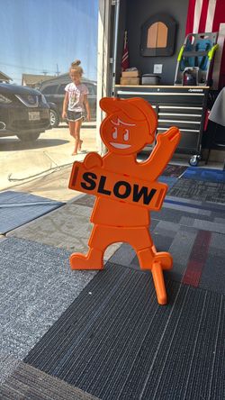 Kids playing. Slow down sign.