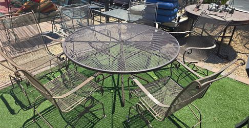 $500 IRON 6 ROCKING CHAIRS AND TABLE