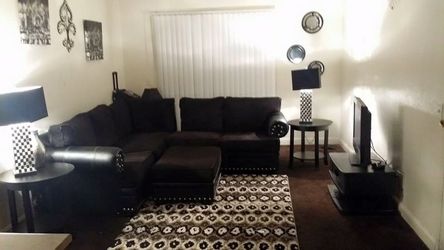 Black sofa, rug, carpet, tables, & chairs