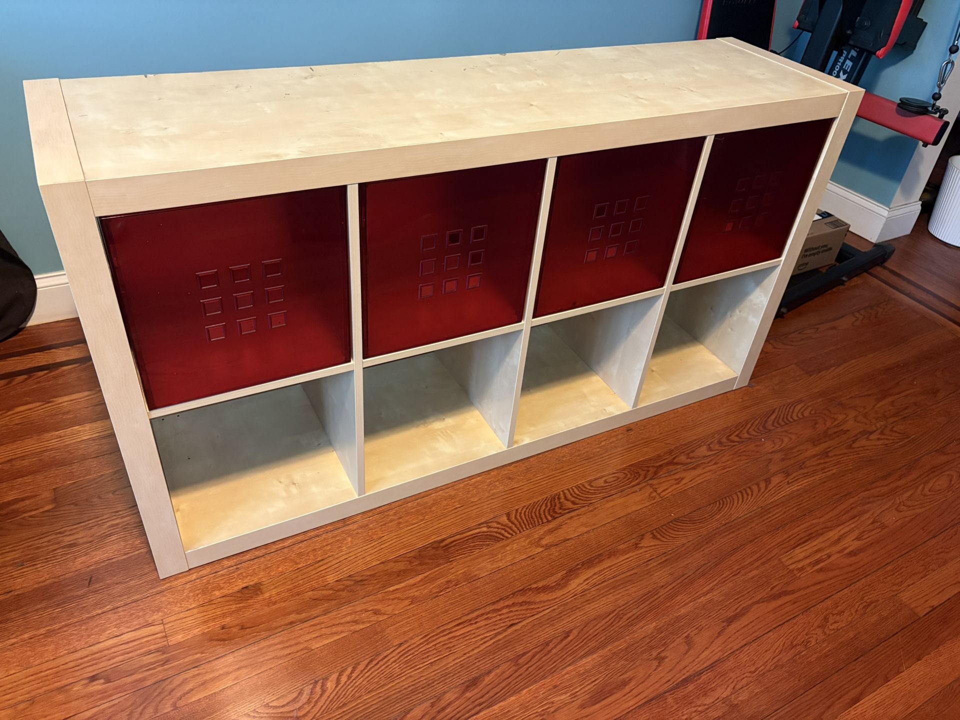 Discontinued IKEA Expedit bookcase in light wood finish with 4 red drawer inserts