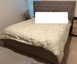 Upholstered grey king bed frame.