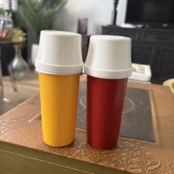vintage Tupperware condiment pump dispensers typically used for ketchup and mustard.