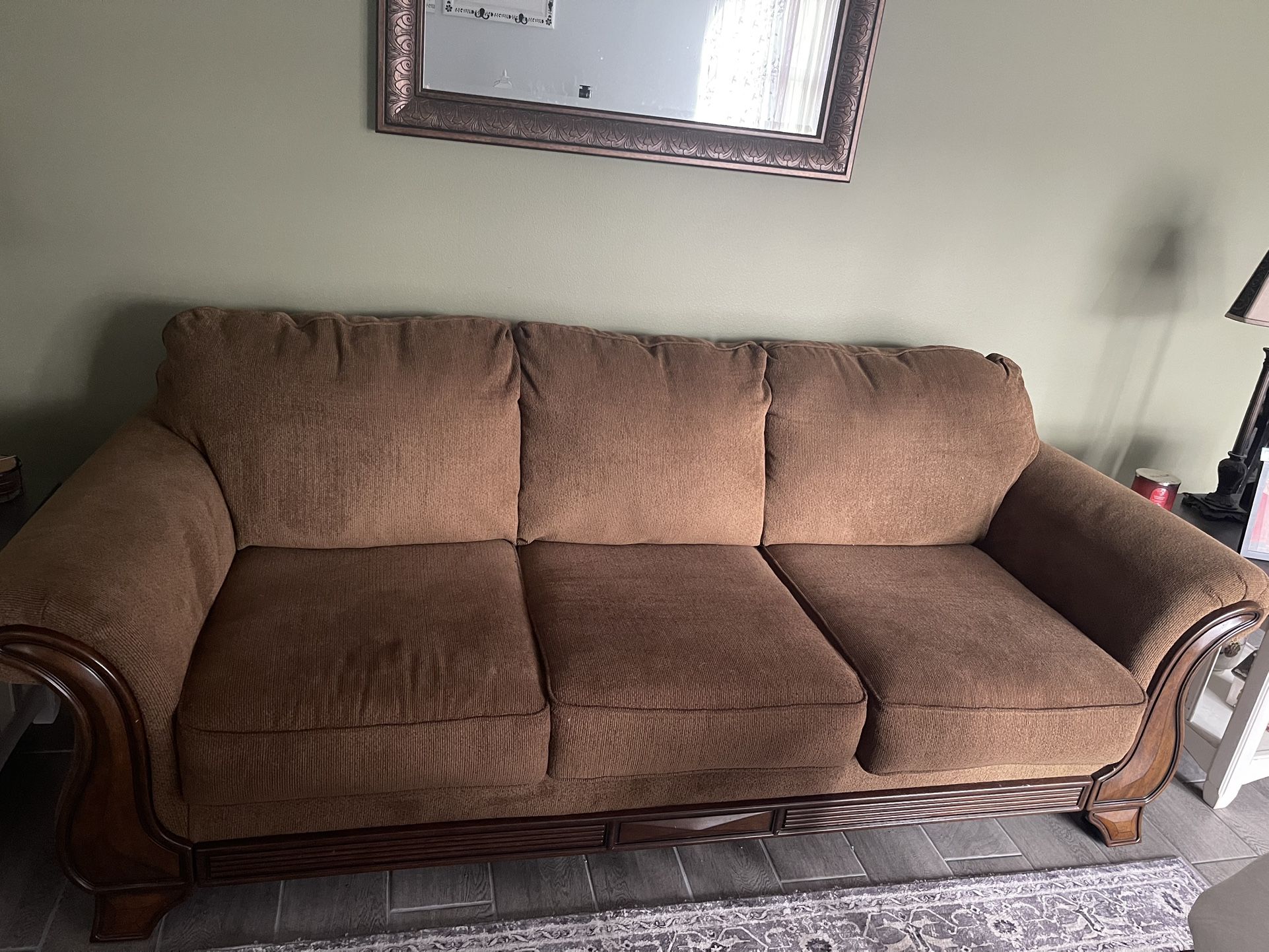 Matching Brown Couch With Wood Trim And Chair With Ottoman