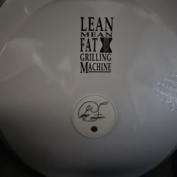 This is an older model George Foreman "Lean Mean Fat Grilling Machine”. Never been used.