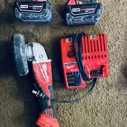 Milwaukee Brushless M18FUEL Angle Grinder along with two M18 REDLITHIUM XC5.0 batteries and charger