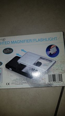 Pop up lighted magnifier/flashlight