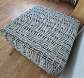The Dylan Slate Accent Ottoman from Bob's Discount Furniture.
