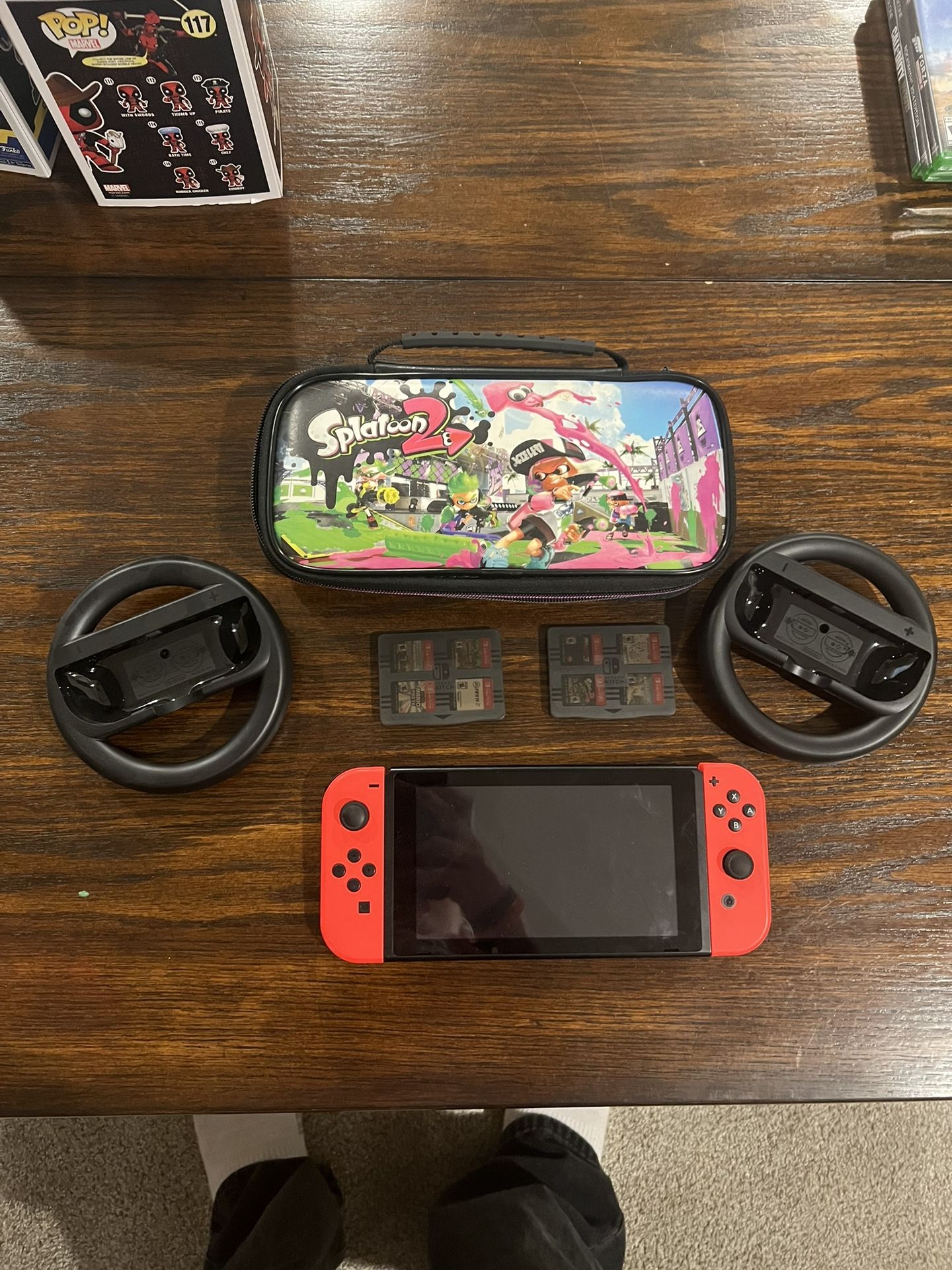 Nintendo Switch With 8 Games, Splatoon 2 Holder/Bag, and Nintendo Switch Mario Cart Controller Wheels