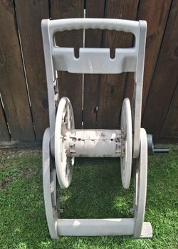 Garden hose reel. Kids push Scooter