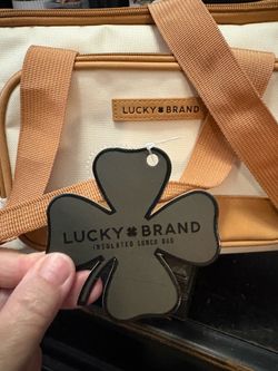 Lucky Brand insulated lunch bag in white with tan trim.