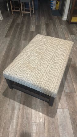 Upholstered Ottoman with Dark Wood Base