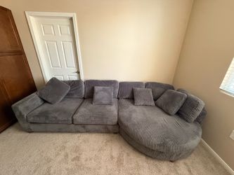 Couch 4-piece modular jumbo corduroy sectional with a curved chaise/end module.