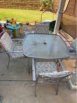 Patio table with matching seats and cushions