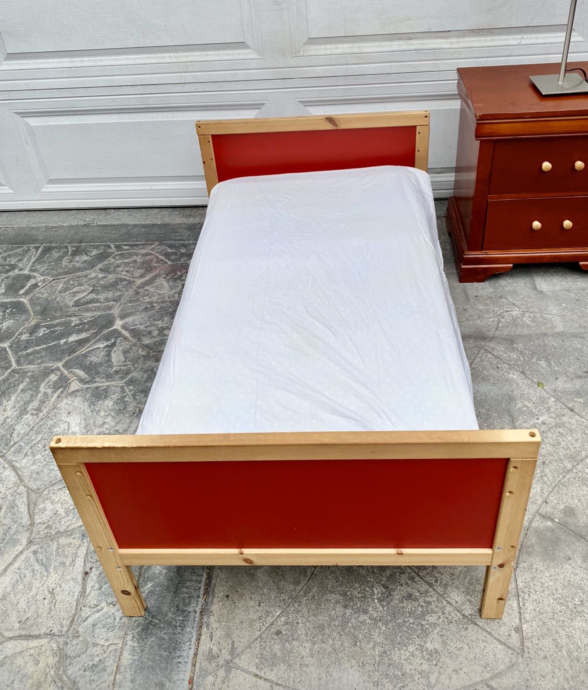Red wooden toddler bed $15, mattress $10.