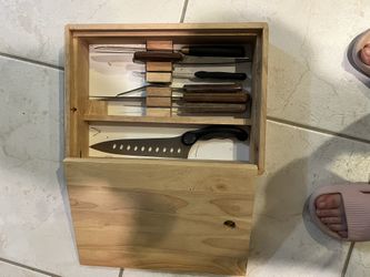 wooden in-drawer knife organizer with various knives stored inside