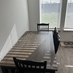 Kitchen table with four chairs and one bench