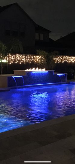 Linear fire pit for use with natural gas