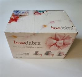 Bowdabra bow maker tool used for crafting ribbons into bows.