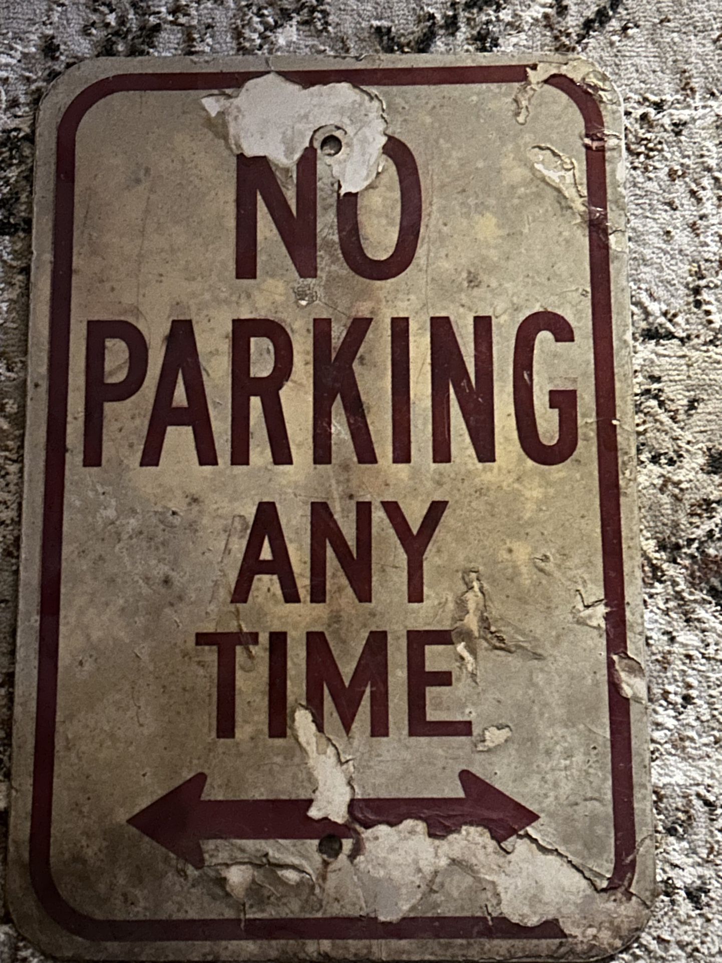 Aged No parking Anytime Sign