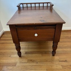Vintage wooden side table with a pull-out drawer that has an inlaid chess board surface
