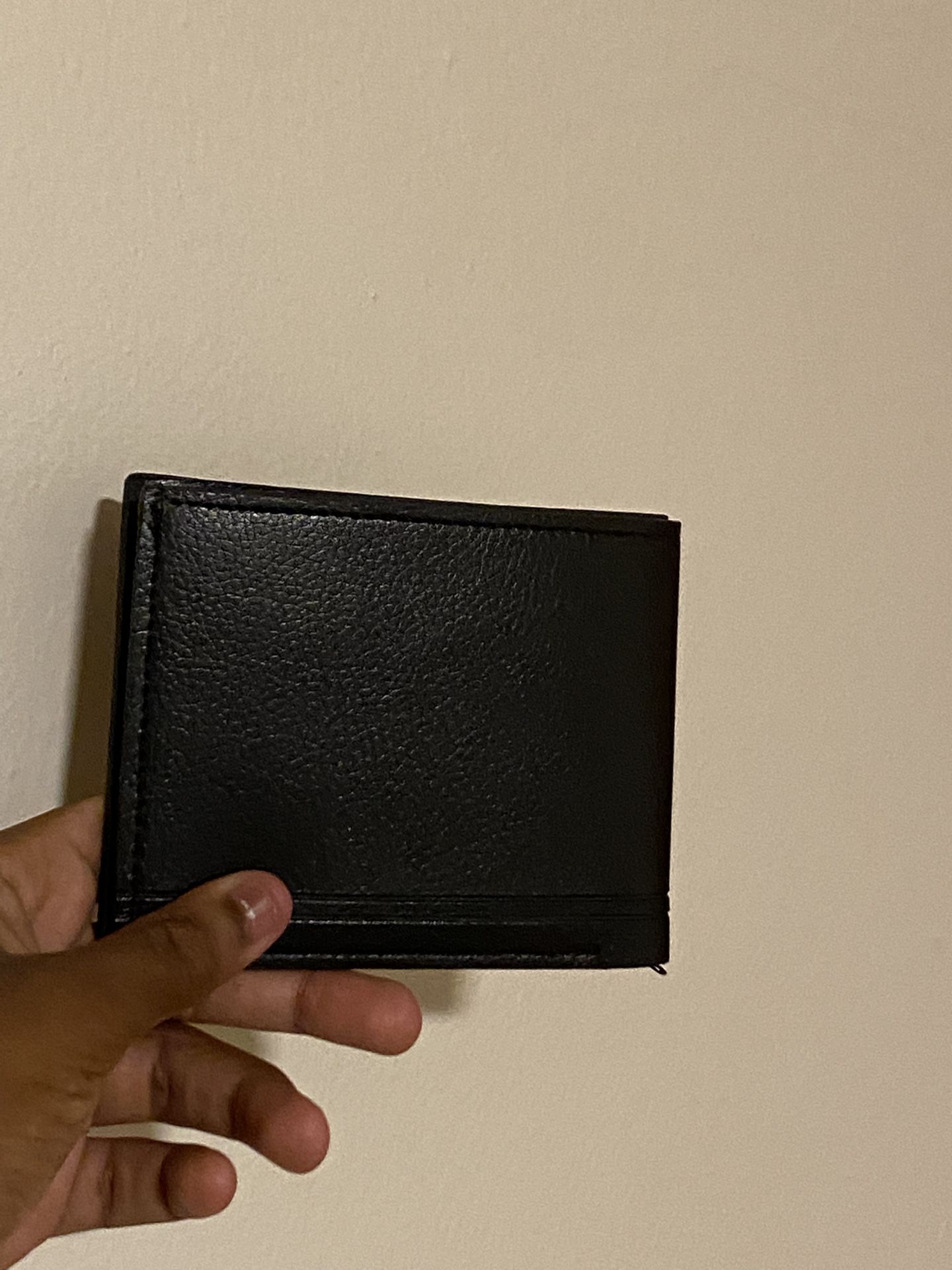 Black leather wallet with card slots and bill compartment