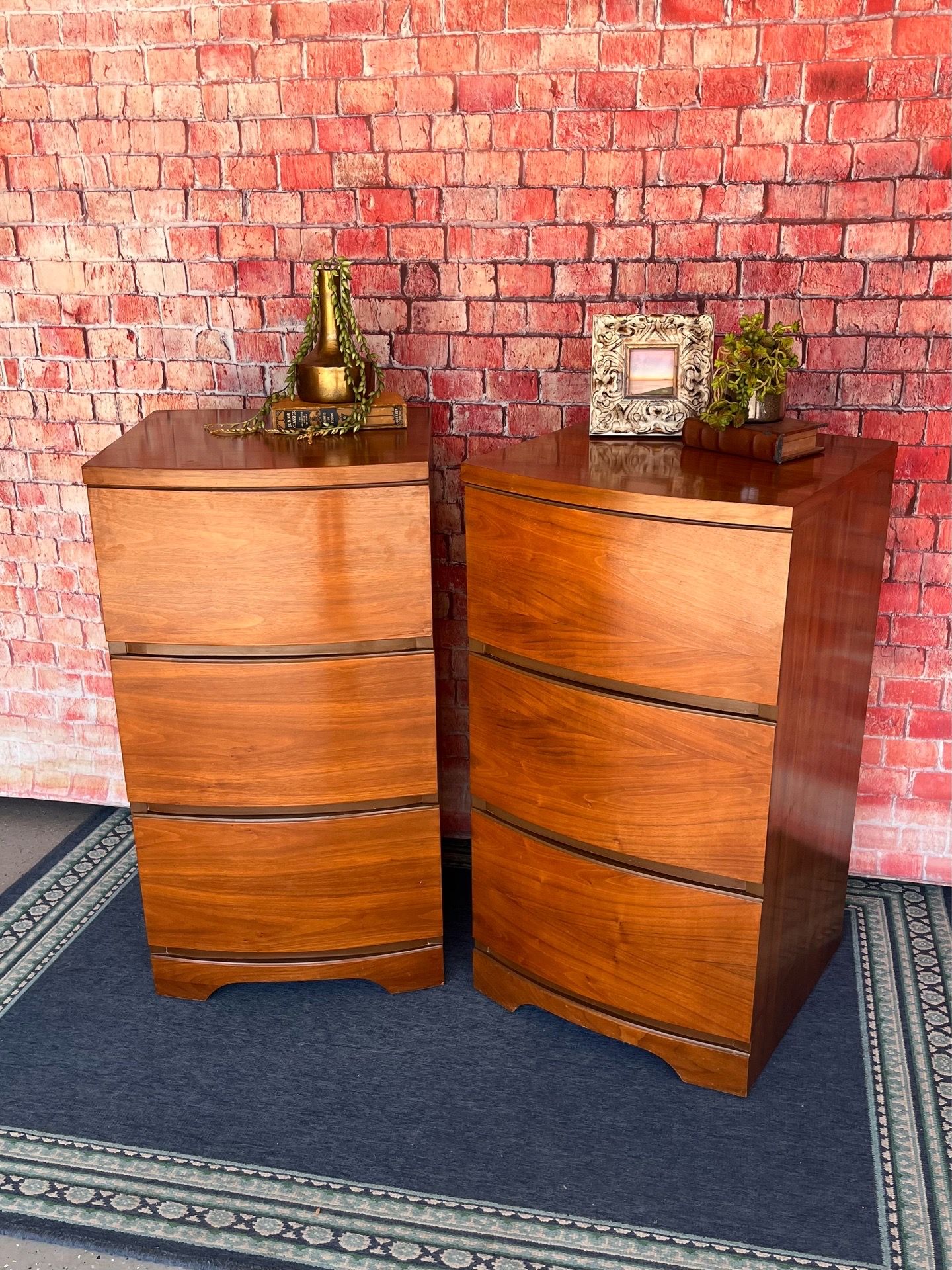A pair of mid-century modern nightstands MCM walnut side tables with curved drawer fronts.