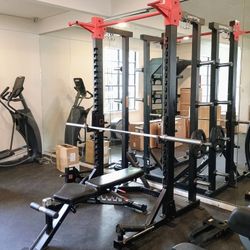 Used Commercial Half Rack W Bar And Some Weight Plates 