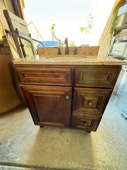 Brown vanity with Countertop and Faucet