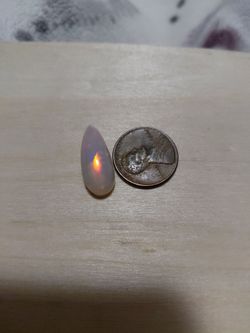 STUNNING AUTHENTIC MULTI FIRE OPAL LOTS OF FLASHES OF COLOR AND IS EVEN MORE BEAUTIFUL IN PERSON AS YOU CAN SEE IS LARGER THAN A PENNY IN LENGTH AND