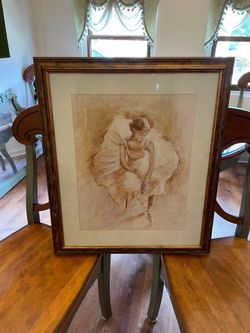 Large gold/bronze colored frame of ballerina