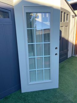 New slab Door fiberglass with blinds and grill between glasses. Almon outside white inside 450 left hand Inswing