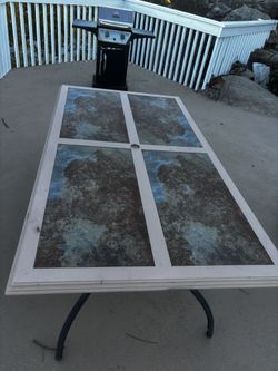 Outdoor ceramic tile table 39in x 71in x 28in (100$)