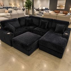 Black corduroy modular sectional sofa with ottoman