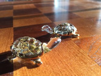 Two glass turtles with gold trim